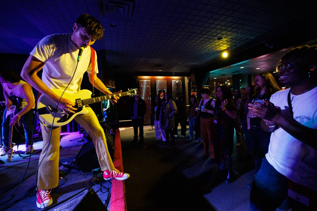 musician on stage in front of crowd